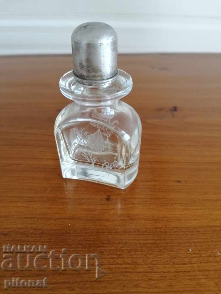 Vintage perfume bottle with a silver cap