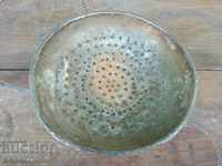 An old copper strainer