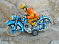 Sheet metal motorcyclist toy