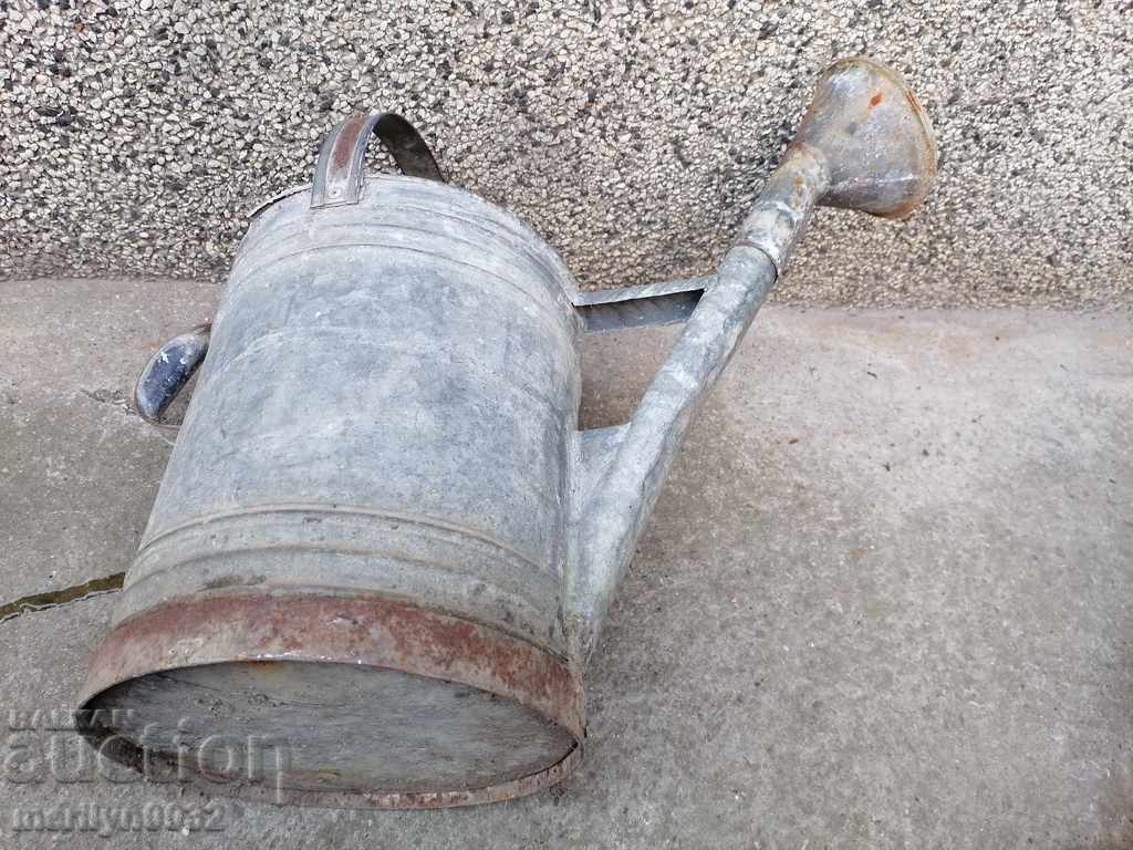 Delivery of Old garden watering can in a tube, watering can Delivery of Old garden watering can in a tube, watering can