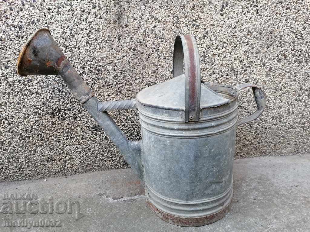 Old garden watering can in a tube, watering can