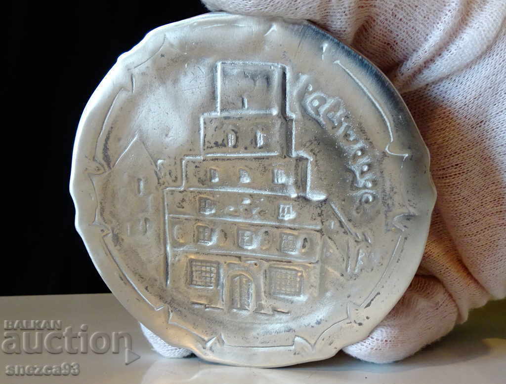 Delivery of Pewter plate, embossed image of a Gothic church