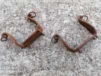 A pair of old wrought iron cats for worms spiked wrought iron