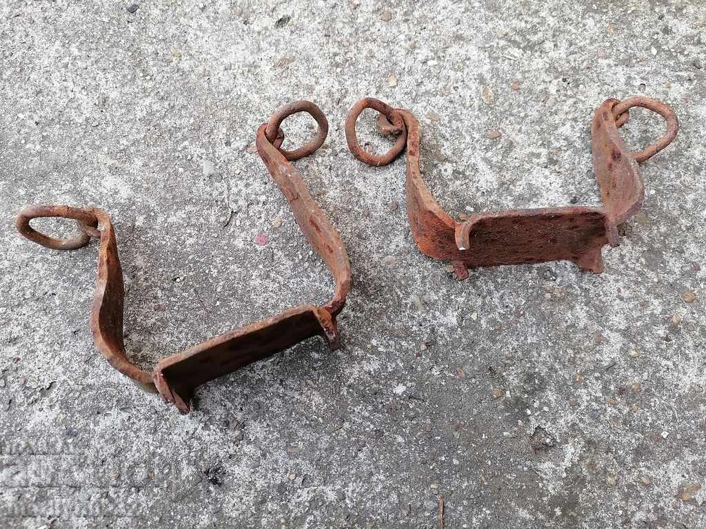 A pair of old wrought iron cats for worms spiked wrought iron