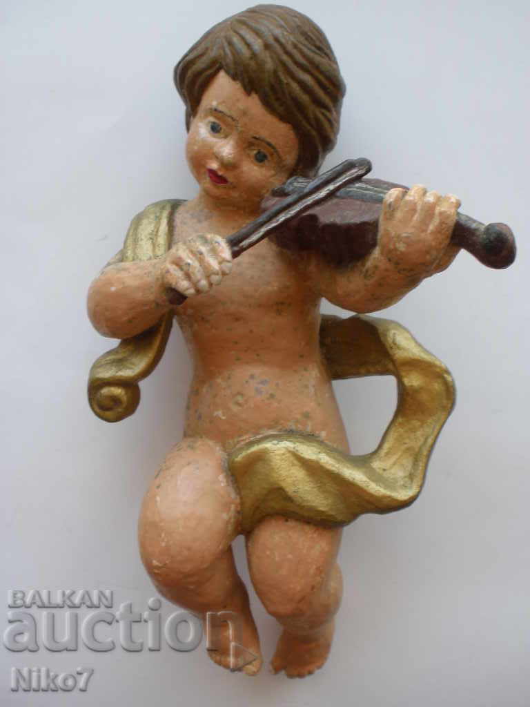 Very old, wooden figure.