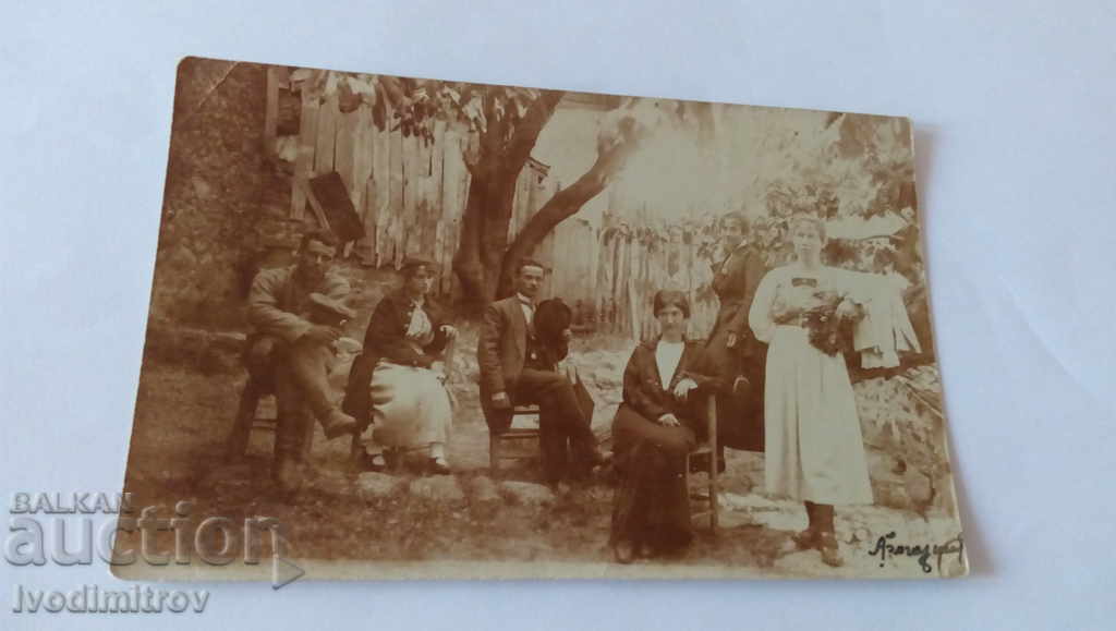 Снимка Мъже и жени под дървото в двора