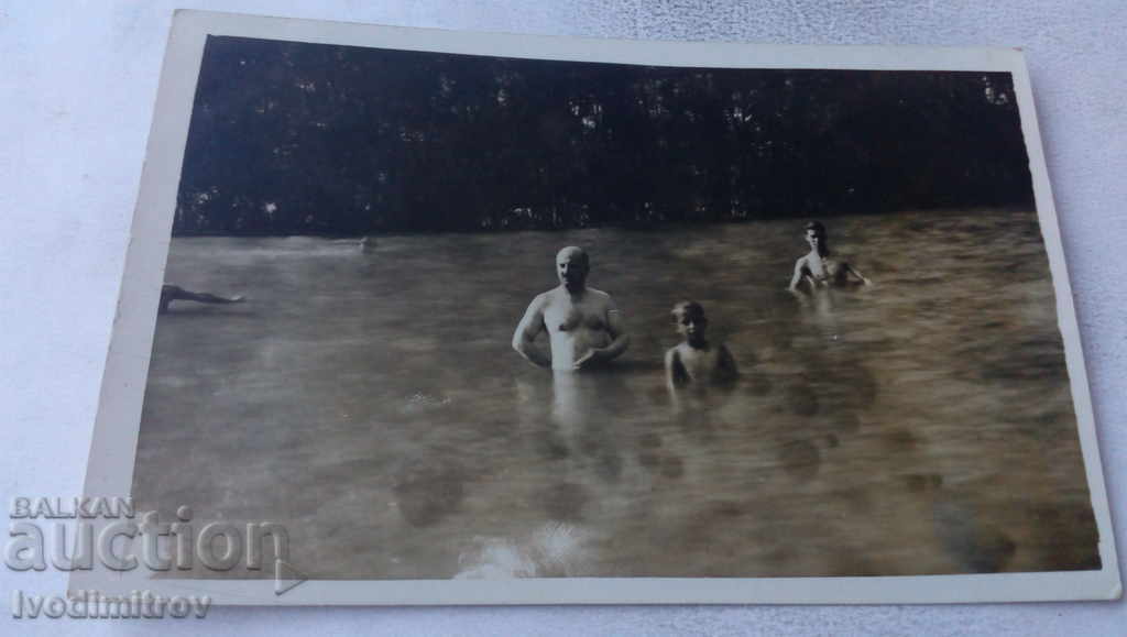 Photo of a man and two boys in the water