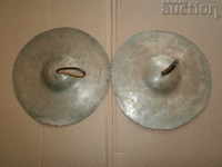 a pair of antique cymbal cymbals