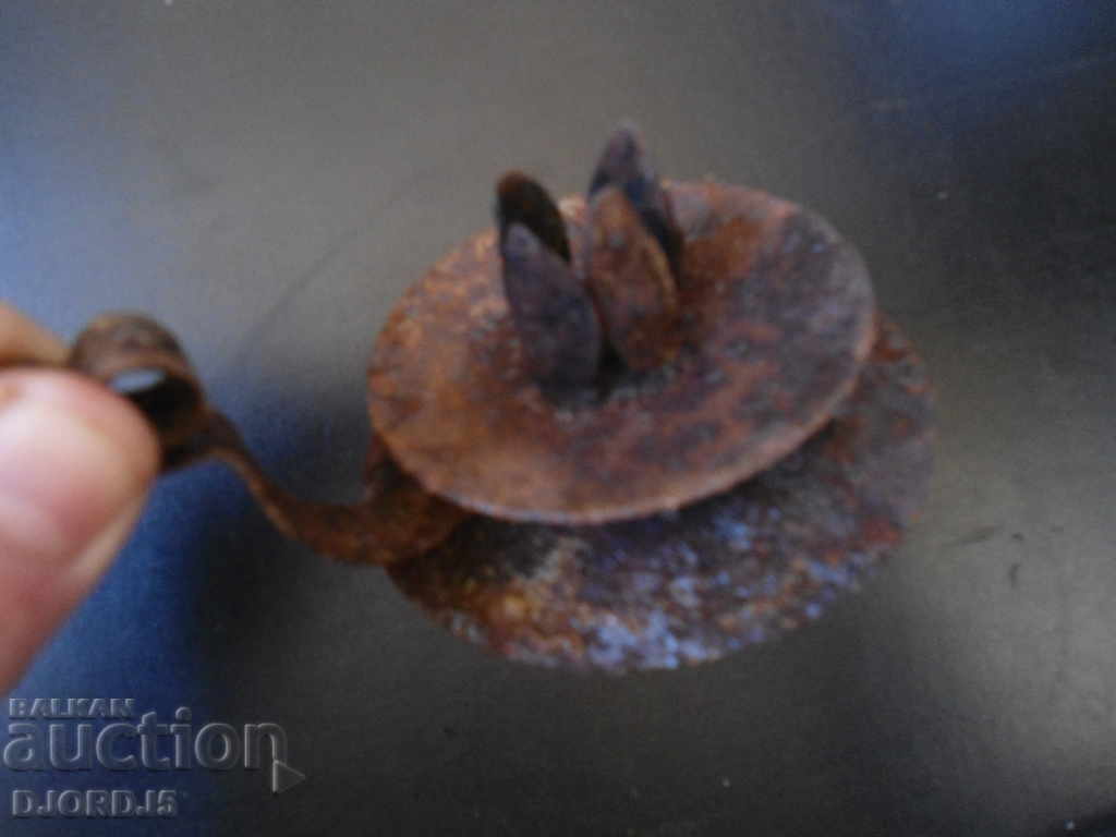 Auction  An old forged candlestick
