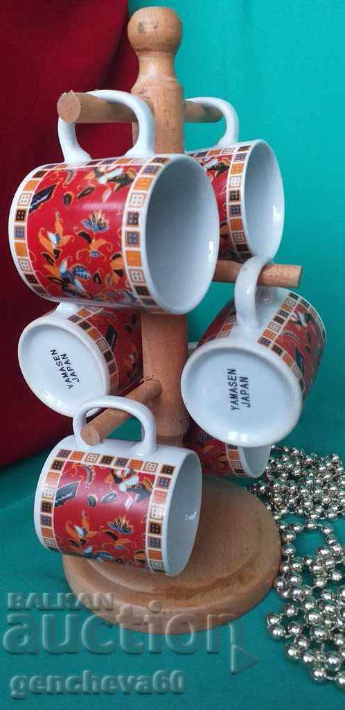 Painted coffee cups with wooden stand