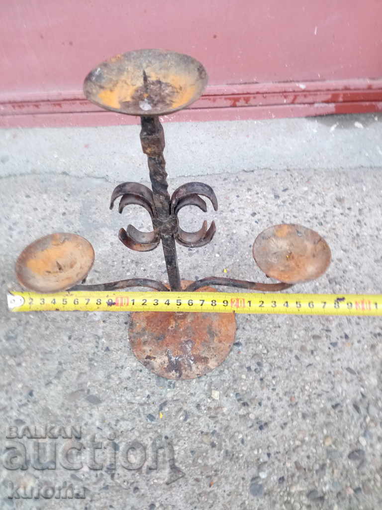 Auction An old forged candlestick Auction An old forged candlestick