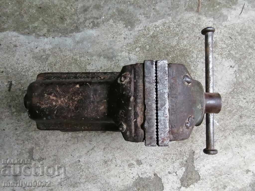 An old vise clamps an iron tool from the SOC WORKS - 7 An old vise clamps an iron tool from the SOC WORKS - 7