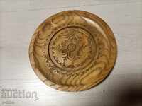 Wooden plate with flower carving