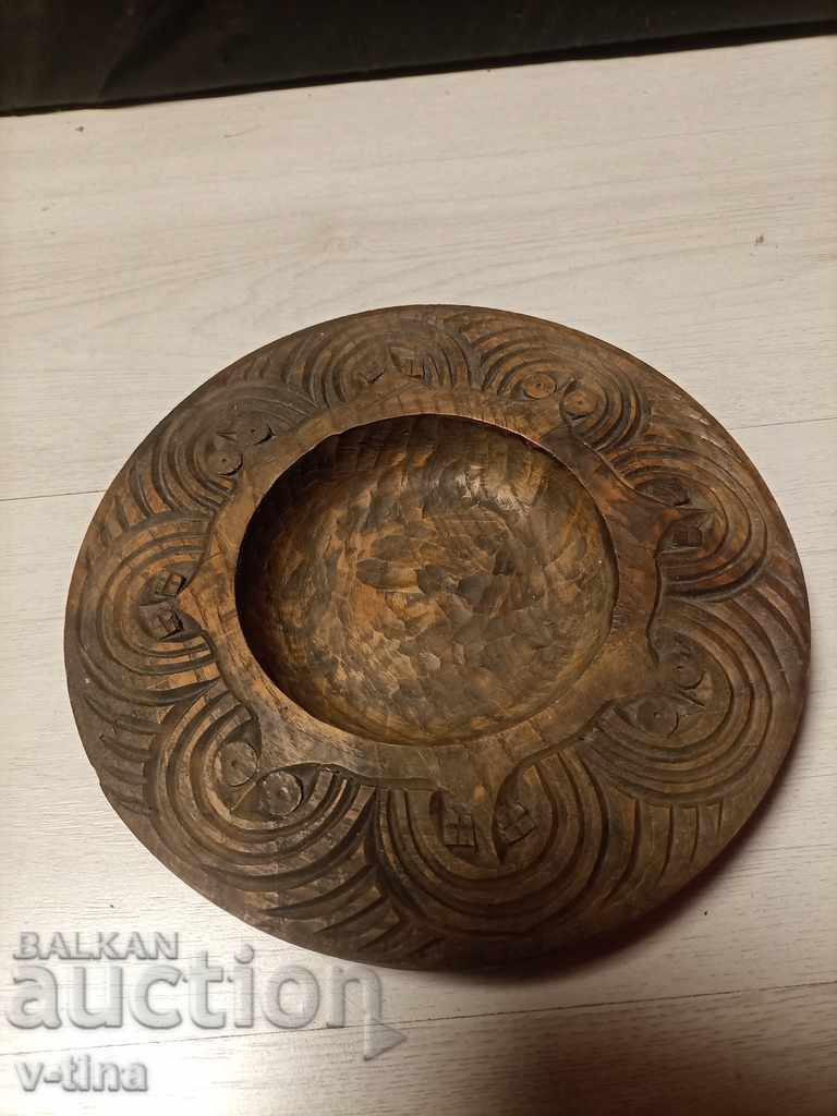 Old wooden plate with intricate and rich woodcarving
