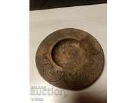 Old wooden plate with intricate and rich woodcarving