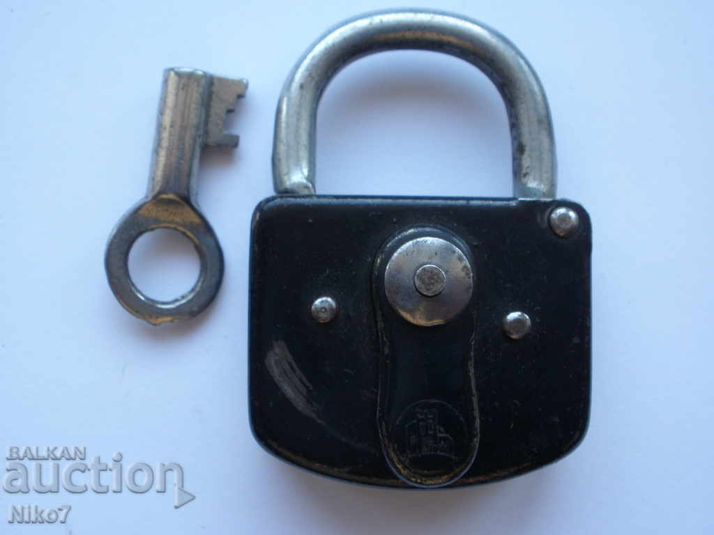 An old, German padlock with a key. An old, German padlock with a key.