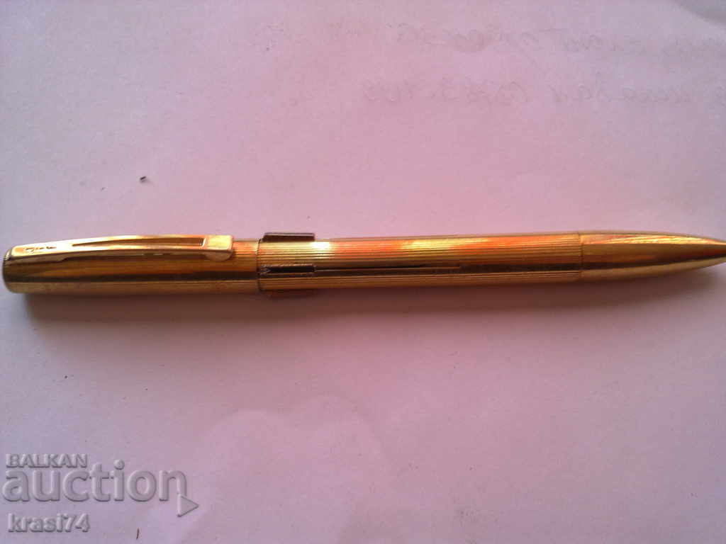 An old, gilded four-color JIF pen