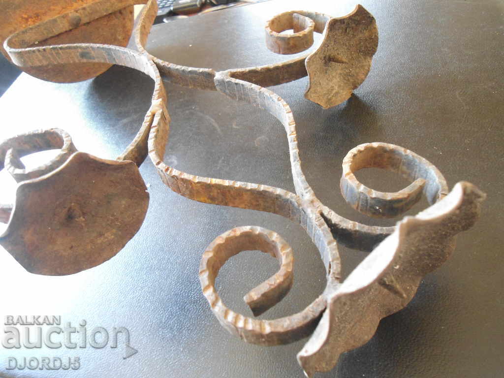 Auction  An old forged candlestick