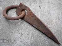 Old wrought iron wedge with wrought iron ring large nail