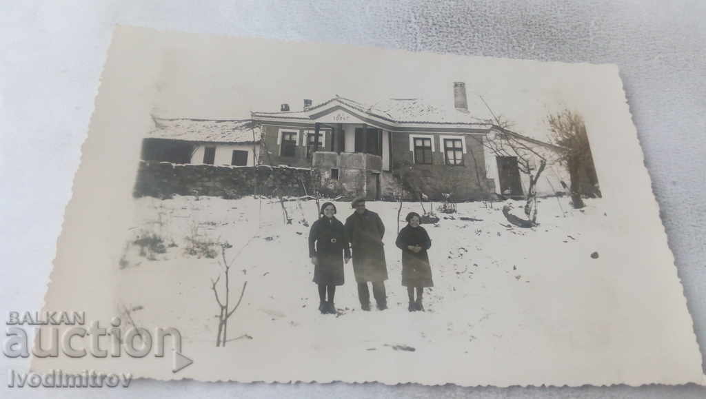 Photo Man woman and child in front of a house built in 1884