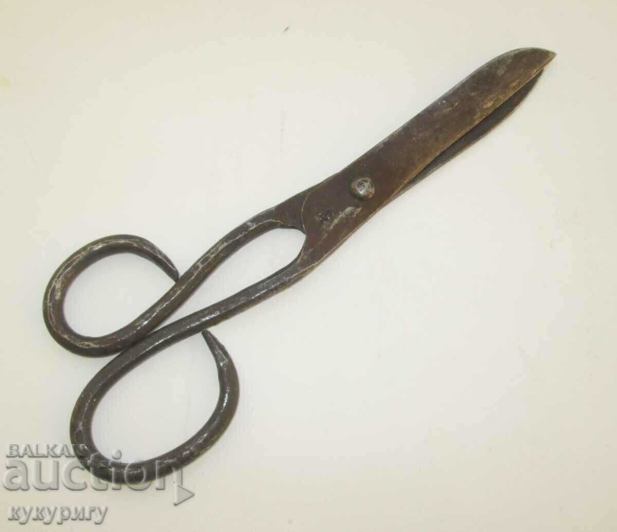 Old forged scissors marked by the master handmade