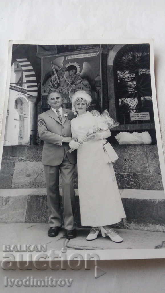 Photo of Sofia Bride with her father in front of a church
