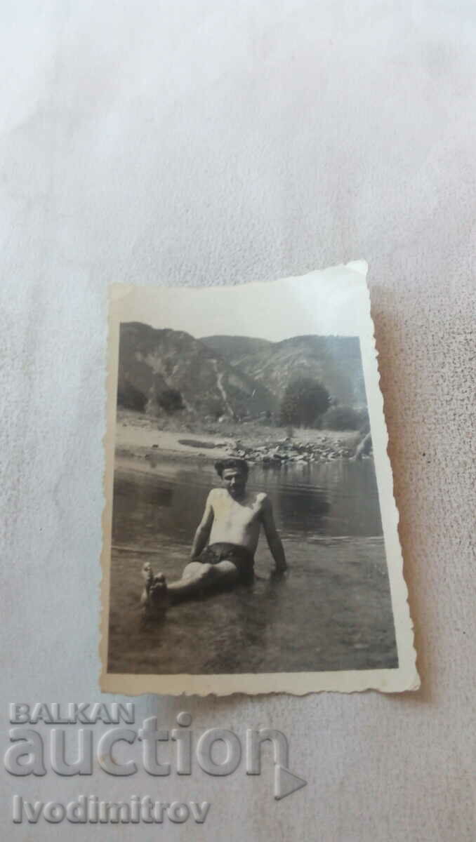 Photo of a swimsuit man in the river