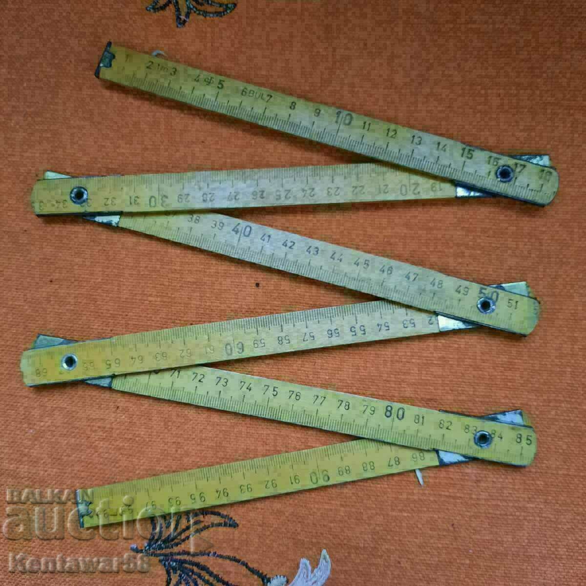 Old folding wooden yardstick. Old folding wooden yardstick.