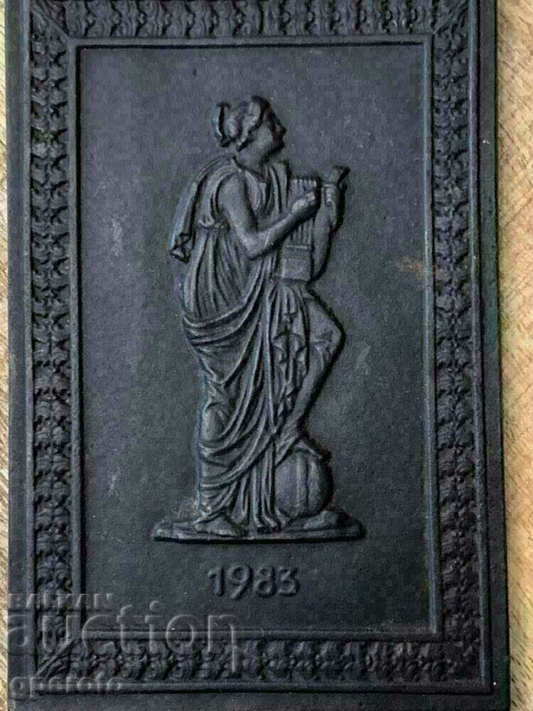 Old metal plate, bas-relief markings