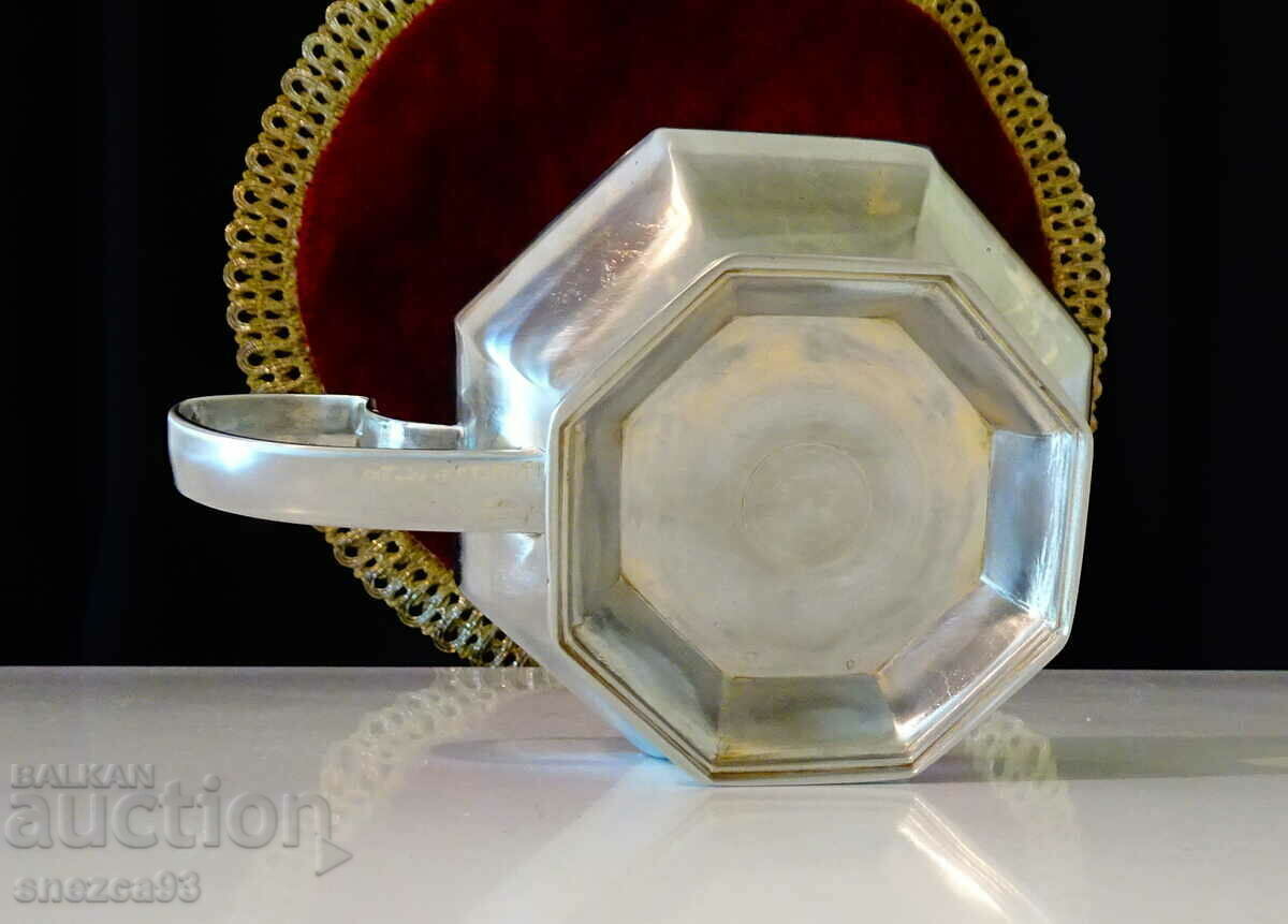 An octagonal tin candlestick. - 5 An octagonal tin candlestick. - 5