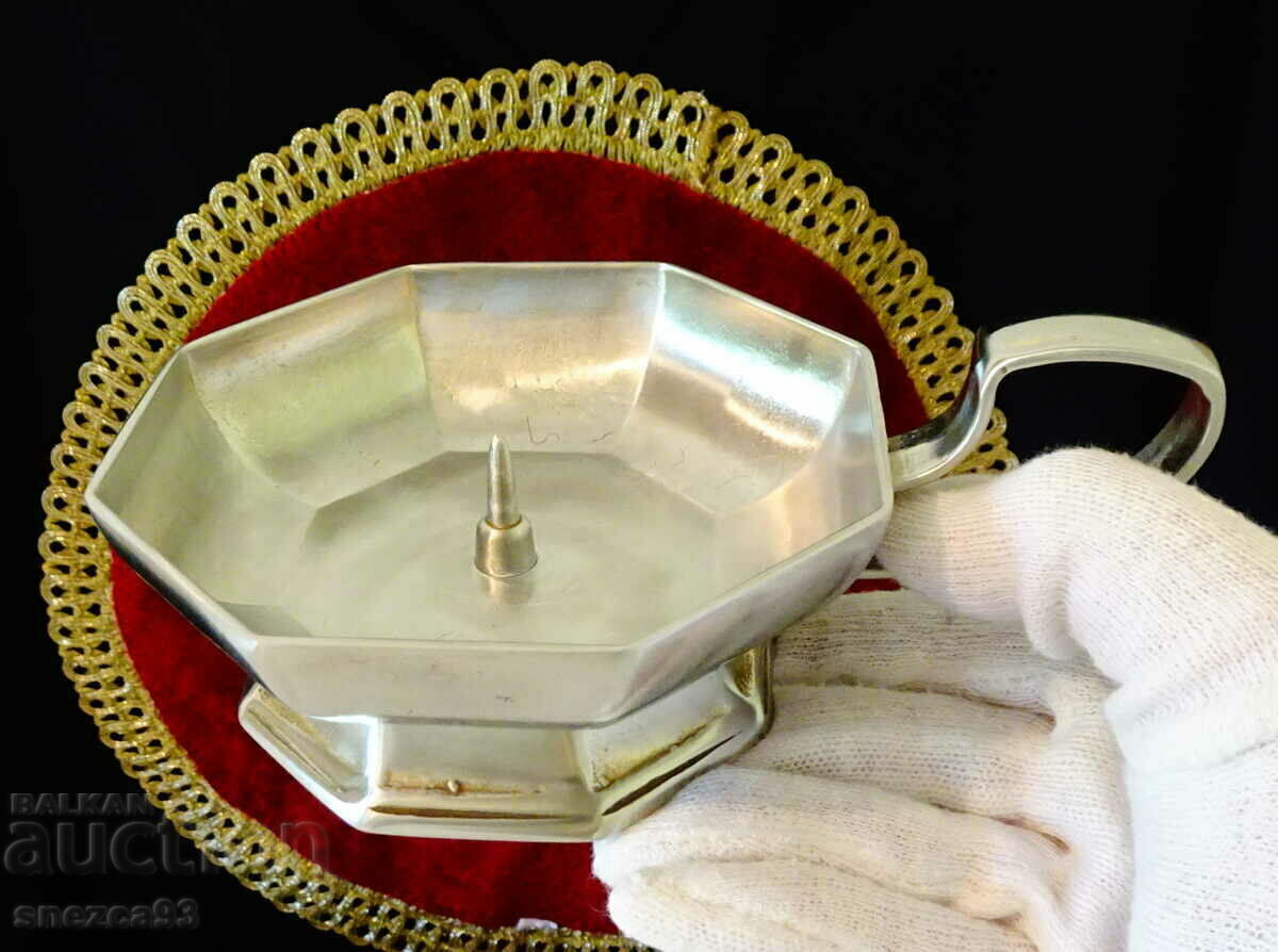 An octagonal tin candlestick. An octagonal tin candlestick.