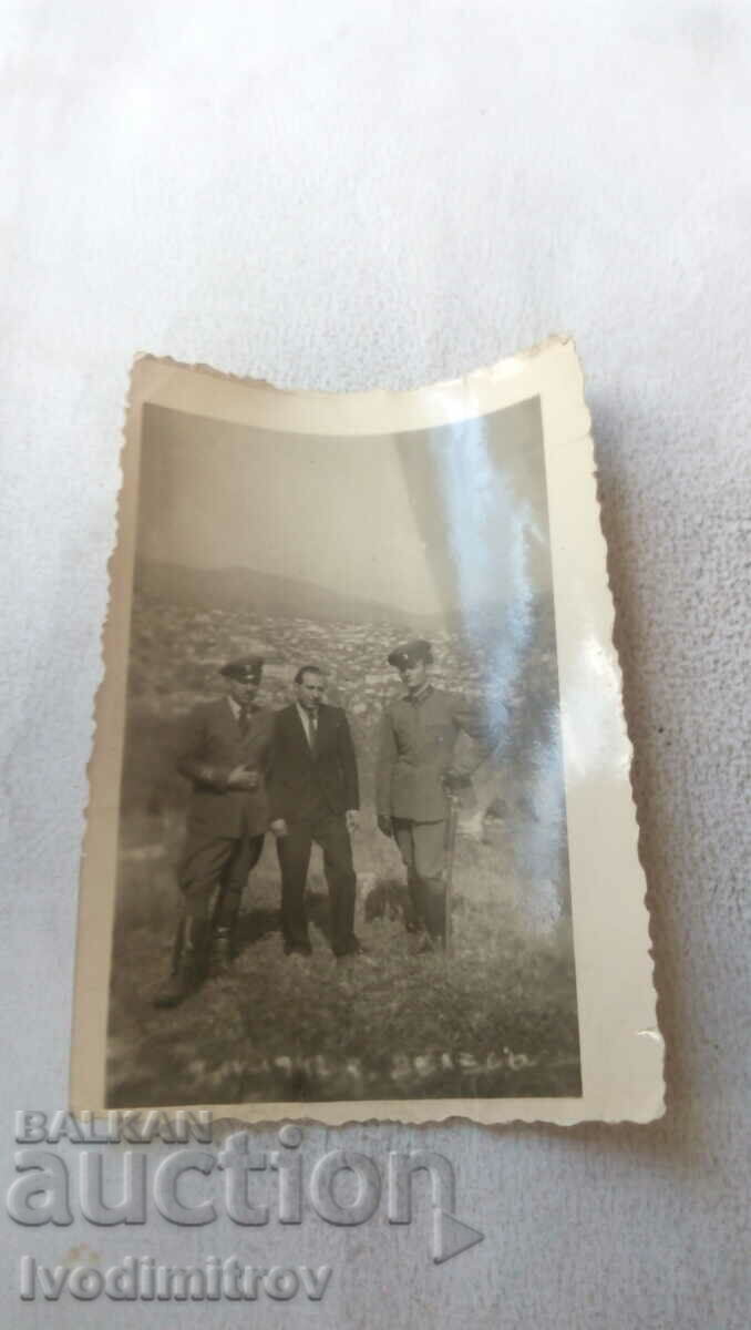 Photo by Veles Two officers and a man in a suit over the city in 1942