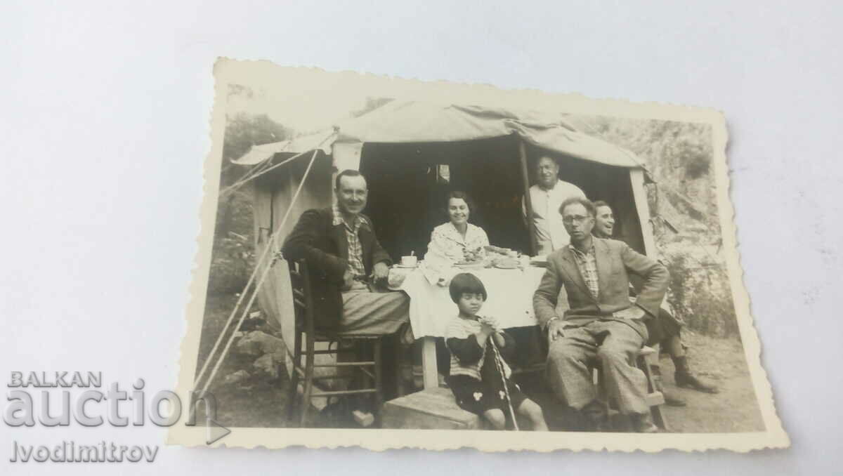 Photo Men women and children in front of a large tent
