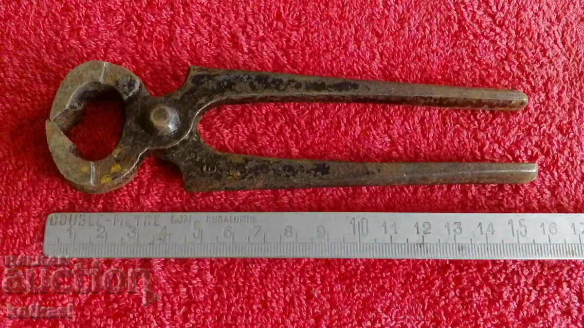 Old forged metal pliers cherped master