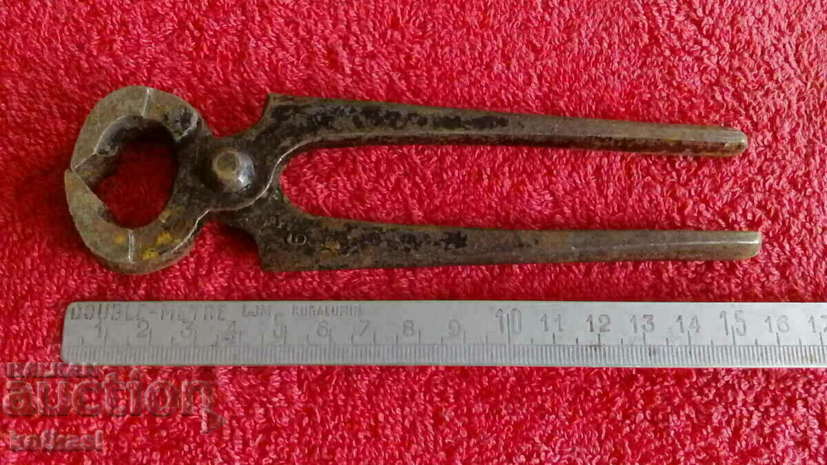 Old forged metal pliers cherped master Old forged metal pliers cherped master