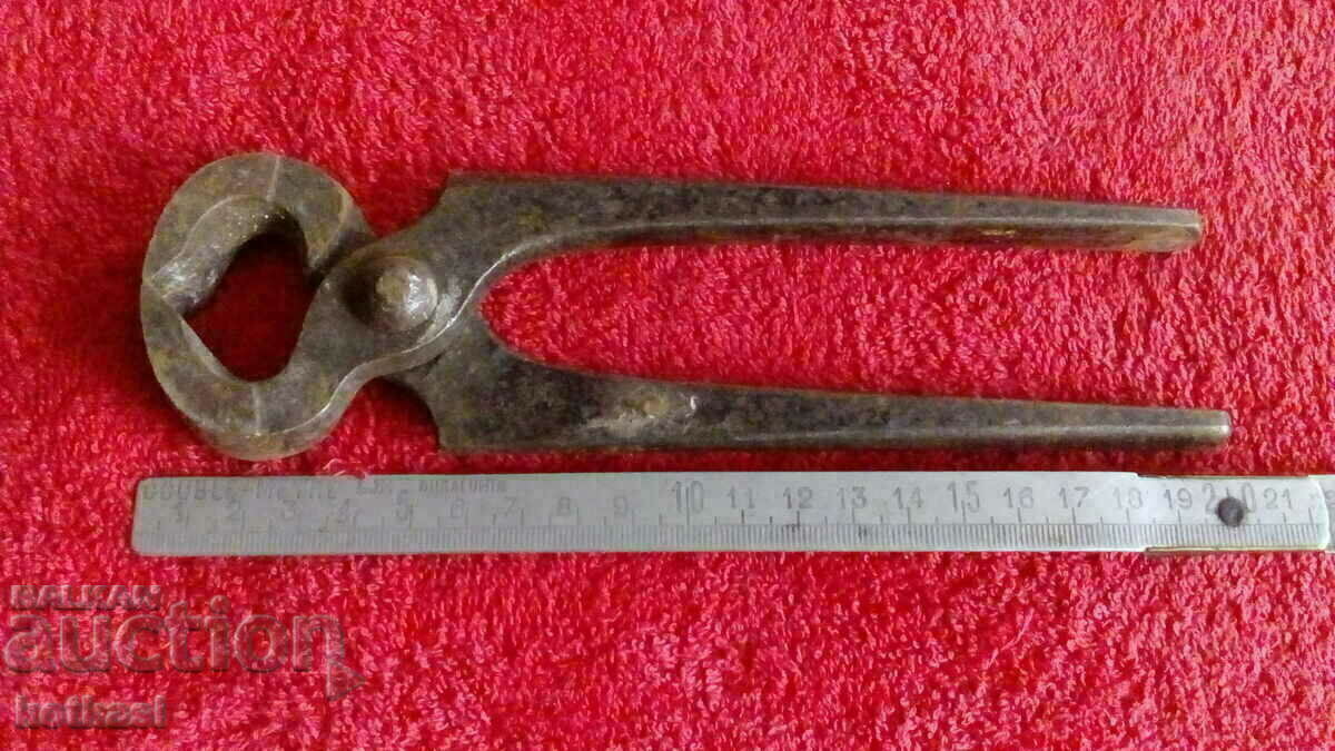 Old forged metal pliers cherped master Old forged metal pliers cherped master