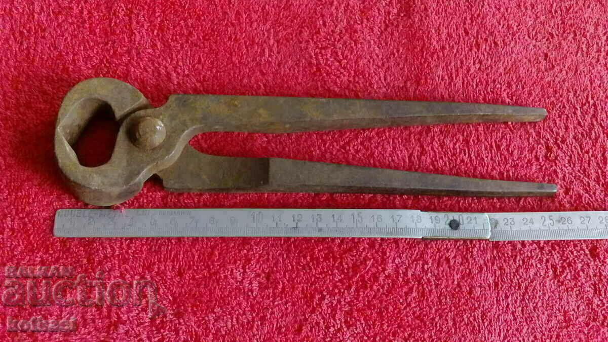 Old forged massive metal pliers serpentine master Old forged massive metal pliers serpentine master