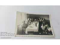 Photo Men women and children at the table 1942
