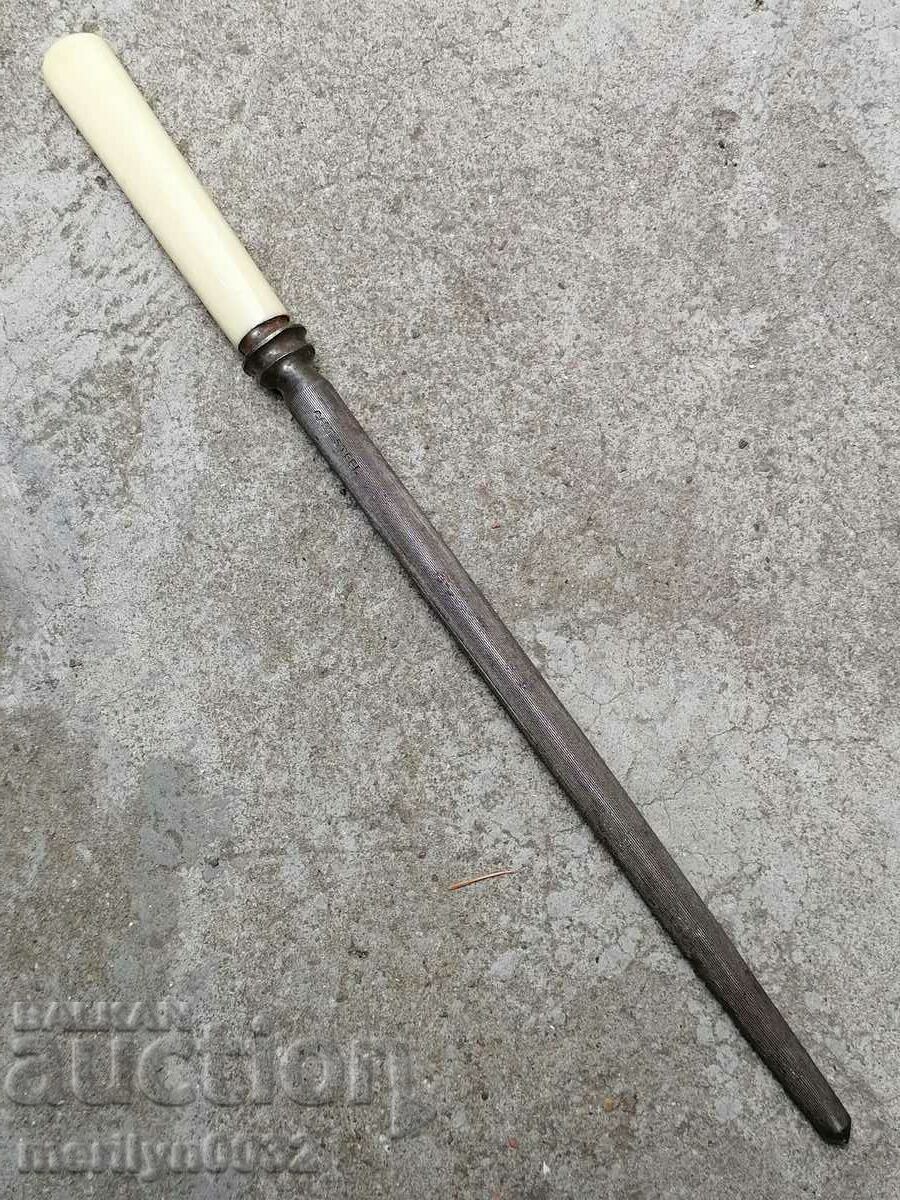 Old table with ivory handle knife sharpener
