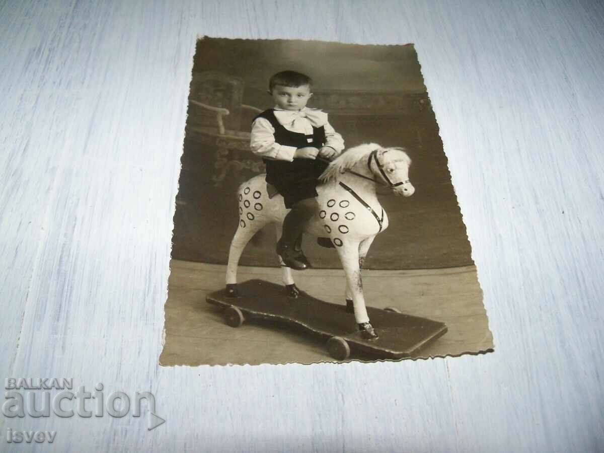 Old picture-card child with a toy