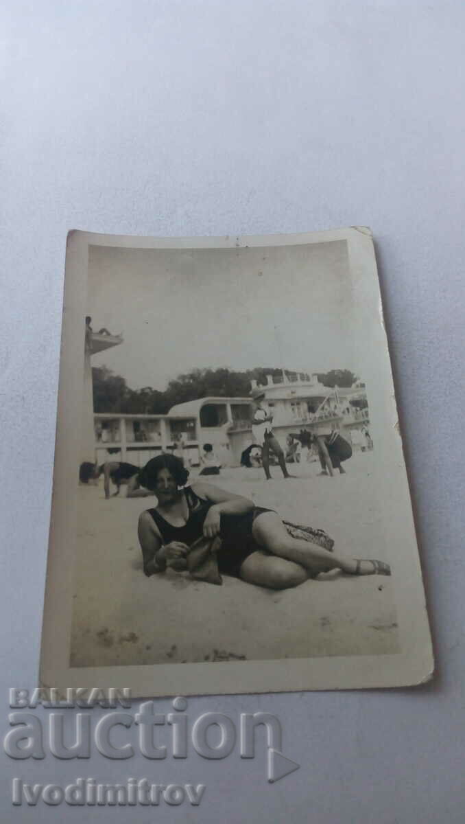 Photo of a woman in a black swimsuit on the beach