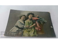 Postcard Two girls with a basket of blue flowers