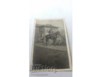 Photo Men on horseback in front of his house