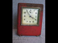 old alarm clock with money box