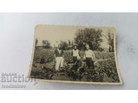 Photo Four men in a bustan with watermelons