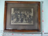 Old photo in a frame of a school class