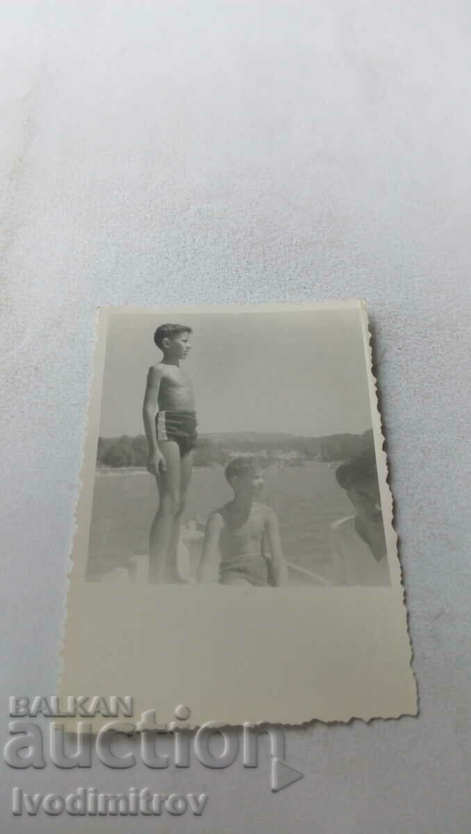 Photo Two boys on a boat in the sea