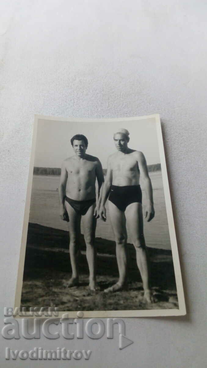Photo Two men in swimsuits on the bank of the river