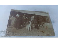 Photo Officer civilians and a dog in the yard