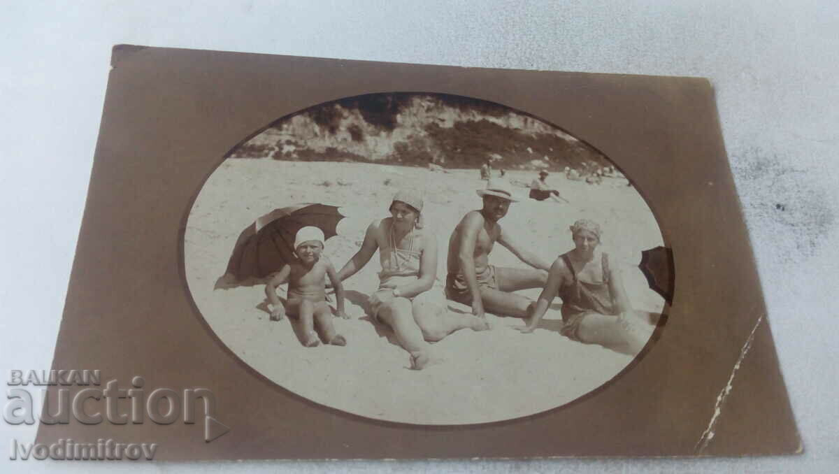 Picture A man, two women and a boy on the beach